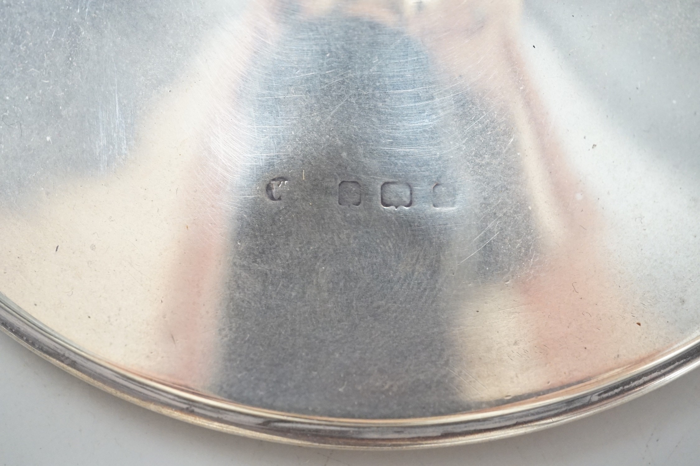 A George V silver mounted capstan inkwell, by Mappin & Webb, London, 1916, diameter 13.6cm and one other silver mounted capstan inkwell.
